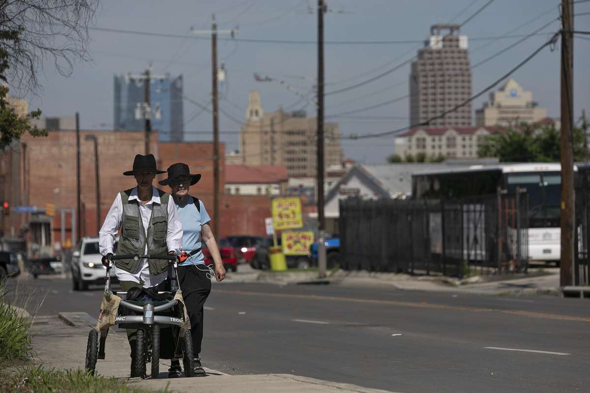 Edie Littlefield Sundby, left, of San Diego, CA, and Joyce Blue Summers, of Alamogordo, NM, walk along East Houston Street, following the Old Spanish Trail through San Antonio on May 7, 2021.